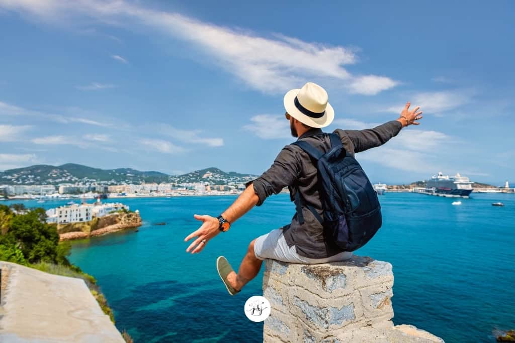 a man on a pier with arms spread